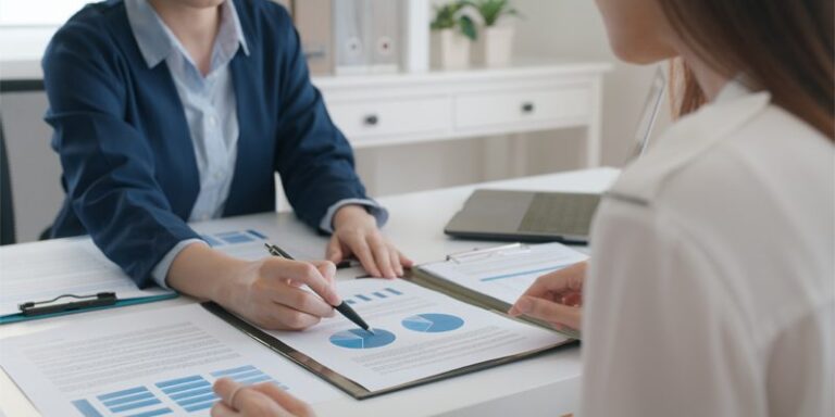 Two people examining a pie chart.