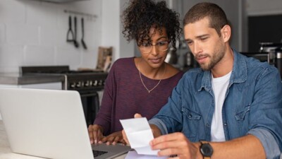 A man and woman reviewing financial documents.
