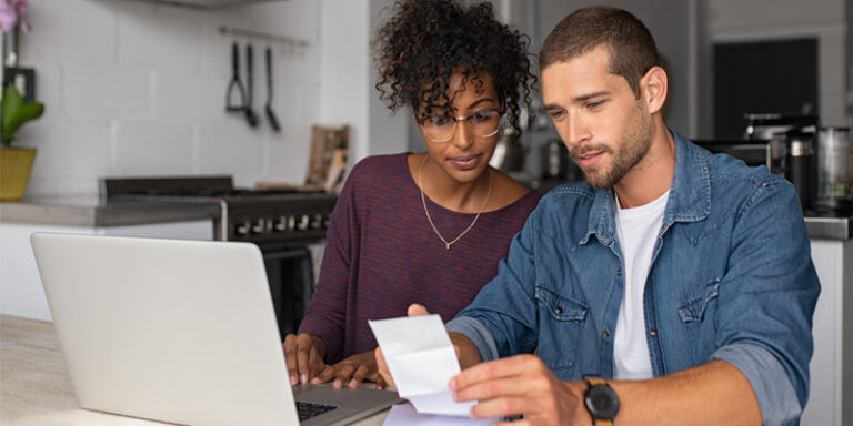 A man and woman reviewing financial documents.