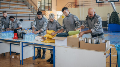 Servicemembers packaging donations as disaster relief.