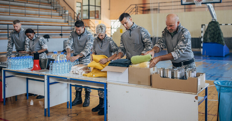 Servicemembers packaging donations as disaster relief.