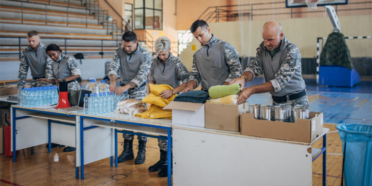 Servicemembers packaging donations as disaster relief.