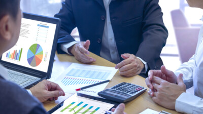 Businessmen looking at graphs and charts.