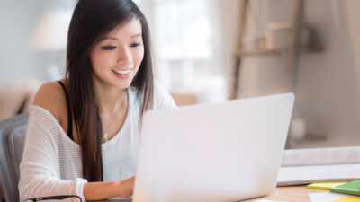 A woman using a laptop.