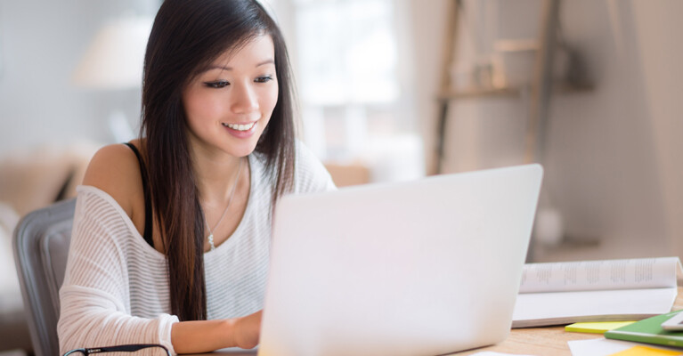 A woman using a laptop.