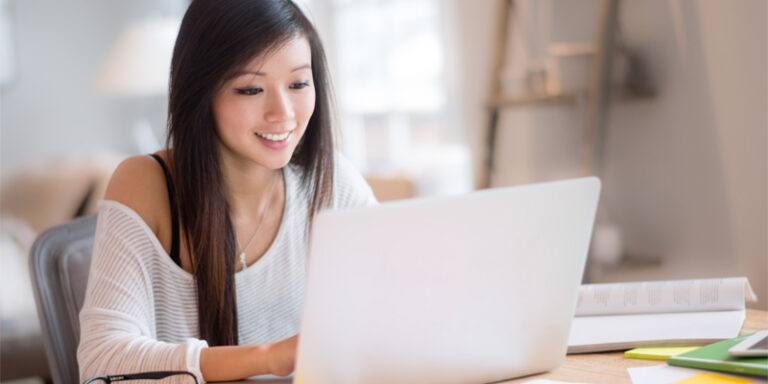 A woman using a laptop.