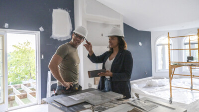 A contractor reviewing renovation plans with the homeowner.