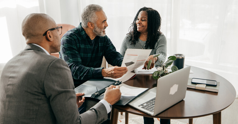 A businessman and a couple reviewing documents.