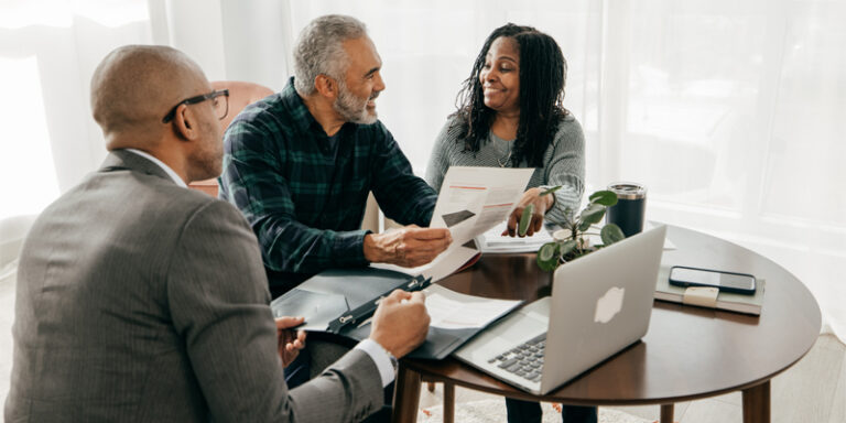 A businessman and a couple reviewing documents.