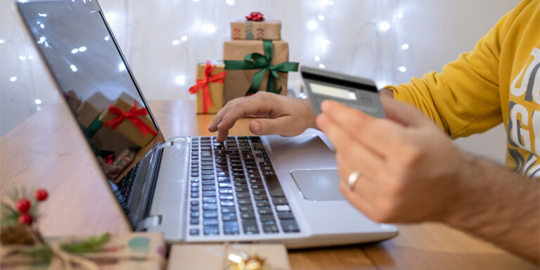 A person using a credit card to make an online purchase.