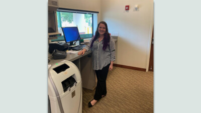 Holly Baker, a WSFS intern, at a bank branch's drive-thru window.