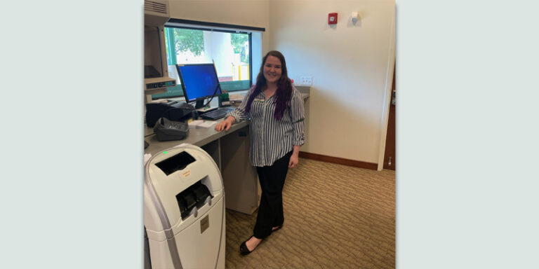 Holly Baker, a WSFS intern, at a bank branch's drive-thru window.