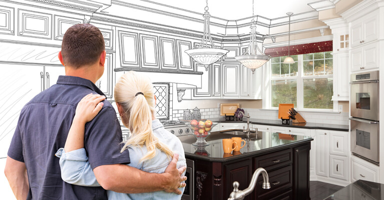 A couple embracing in front of an image of their kitchen, half of which is planned illustration and half of which is a photograph.