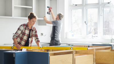 Man and woman doing home renovation work.