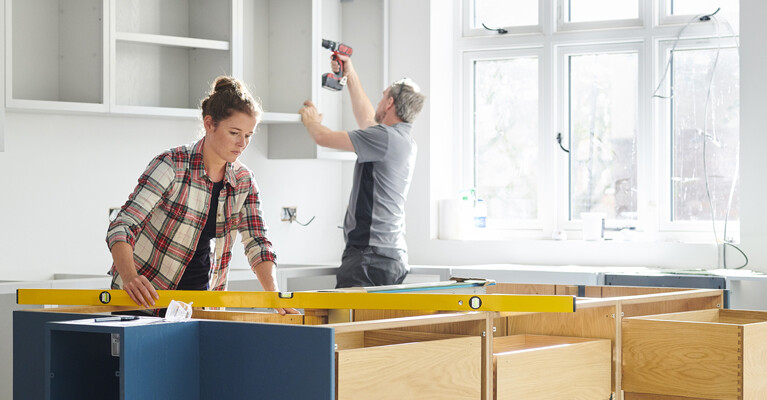 Man and woman doing home renovation work.