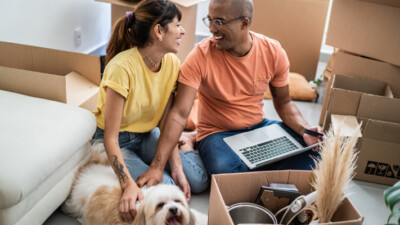 Young couple with dog studying the housing market.