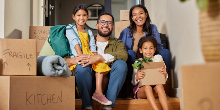 A family surrounded by moving boxes.