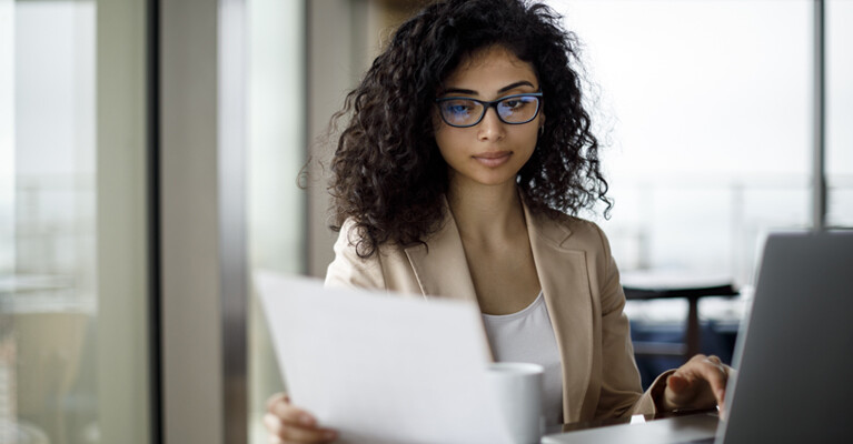 Woman looking at paperwork.