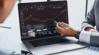 Businessmen looking at stock chart on computer.