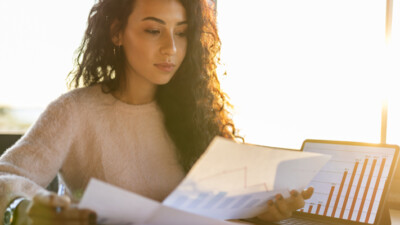 A woman reviewing graphs and charts.