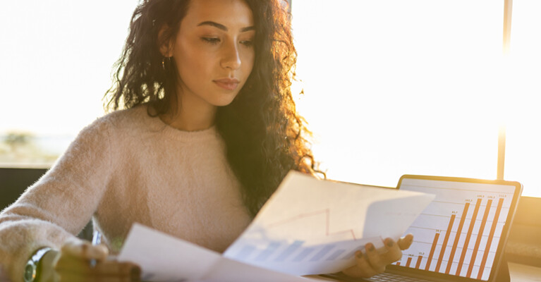 A woman reviewing graphs and charts.