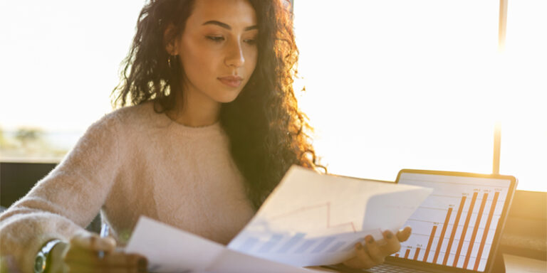 A woman reviewing graphs and charts.