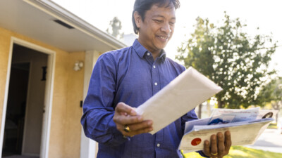 A man looking through his mail.