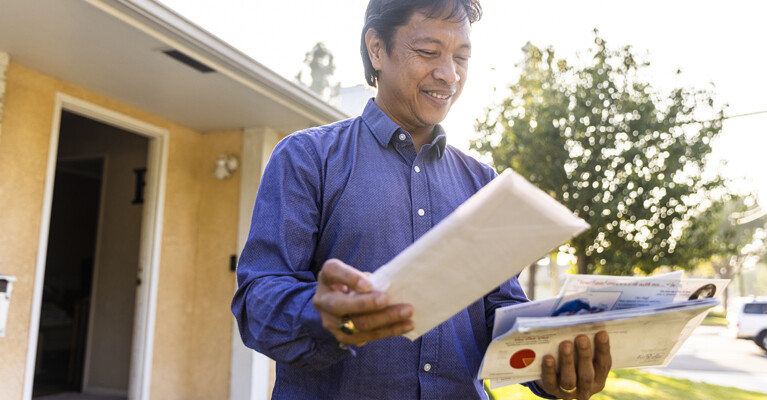 A man looking through his mail.