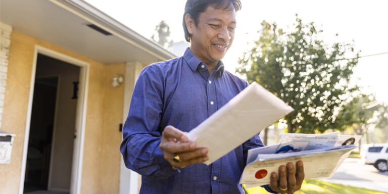 A man looking through his mail.