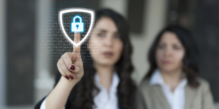 Two women touching a digital security icon.