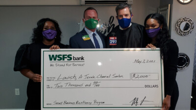 Lavish Salon employees, WSFS Associates, and a Fox 29 news anchor, holding a prop check for $2000.