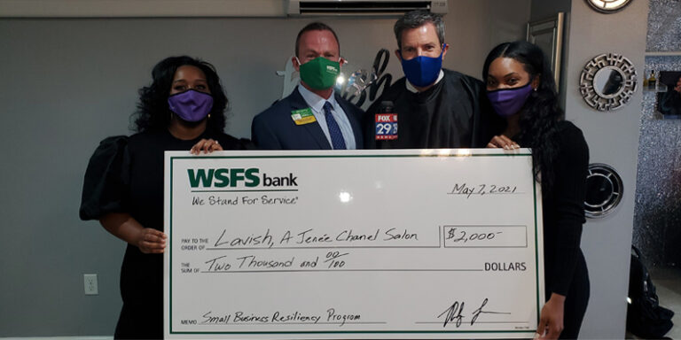 Lavish Salon employees, WSFS Associates, and a Fox 29 news anchor, holding a prop check for $2000.