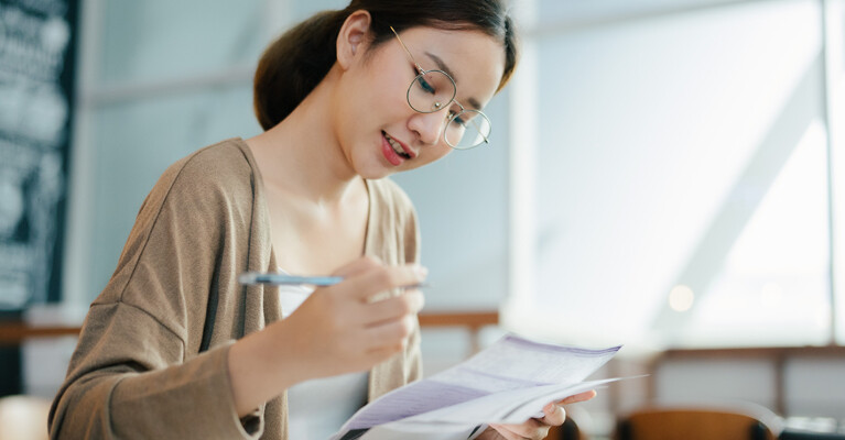 A young woman filling out paperwork.