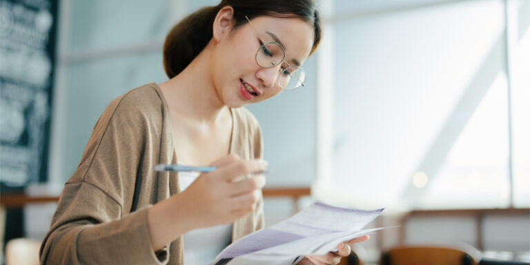 A young woman filling out paperwork.