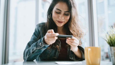 Woman scanning a check using her phone.