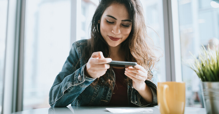 Woman scanning a check using her phone.