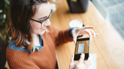 A woman using mobile deposit on a check.