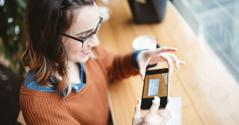 A woman using mobile deposit on a check.