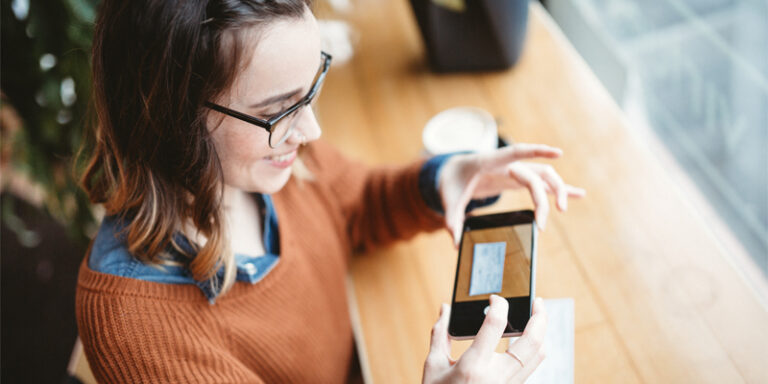 A woman using mobile deposit on a check.