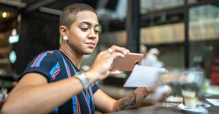 Woman scanning a check using her phone.