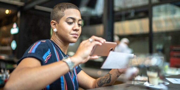 Woman scanning a check using her phone.
