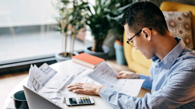 A man making calculations on his phone calculator app.