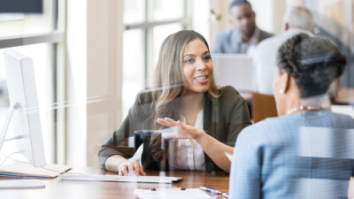 A businesswoman speaking with a customer.