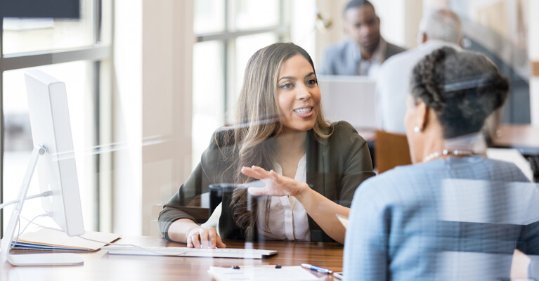 A businesswoman speaking with a customer.