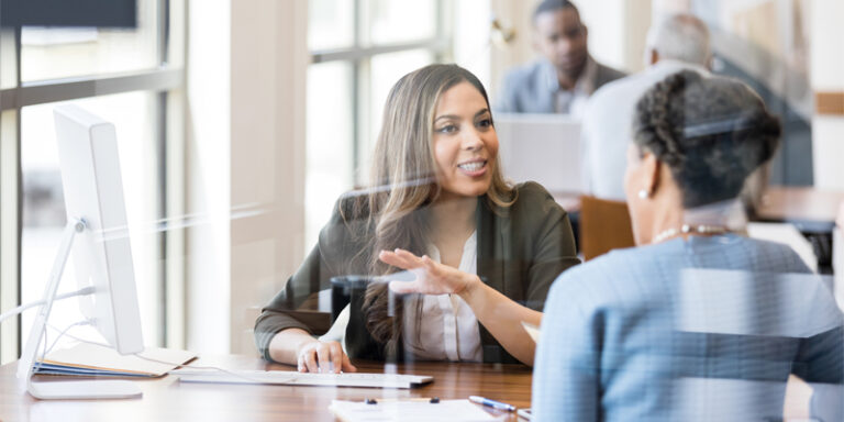 A businesswoman speaking with a customer.