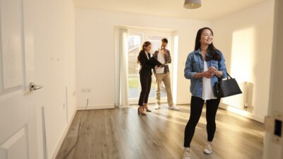 A real estate agent showing a house to a couple.