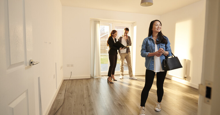 A real estate agent showing a house to a couple.