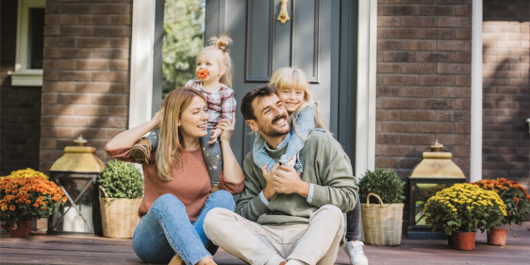 A family sitting on their front porch.