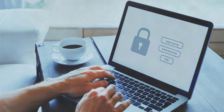 Person logging into website on laptop.