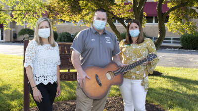 WSFS Associates and Anthony Penna Charitable Fund representative, holding a guitar.